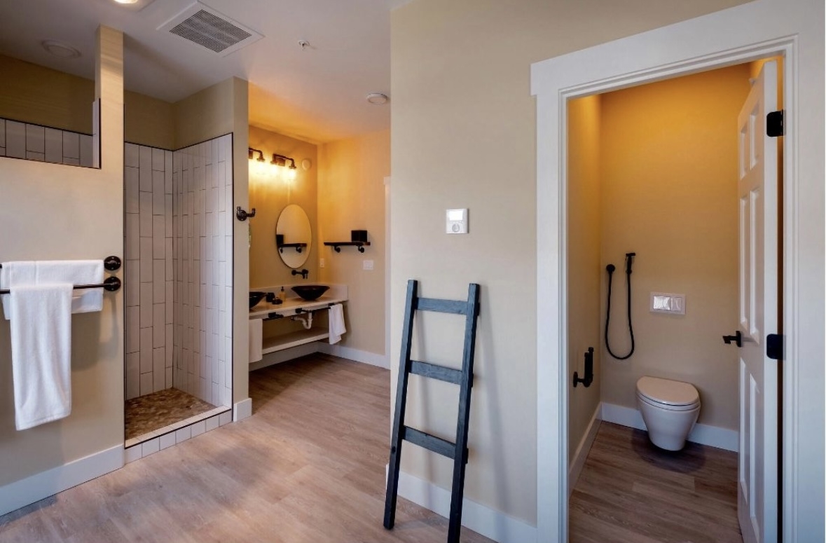 Bathroom with shower, toilet and double glass sinks