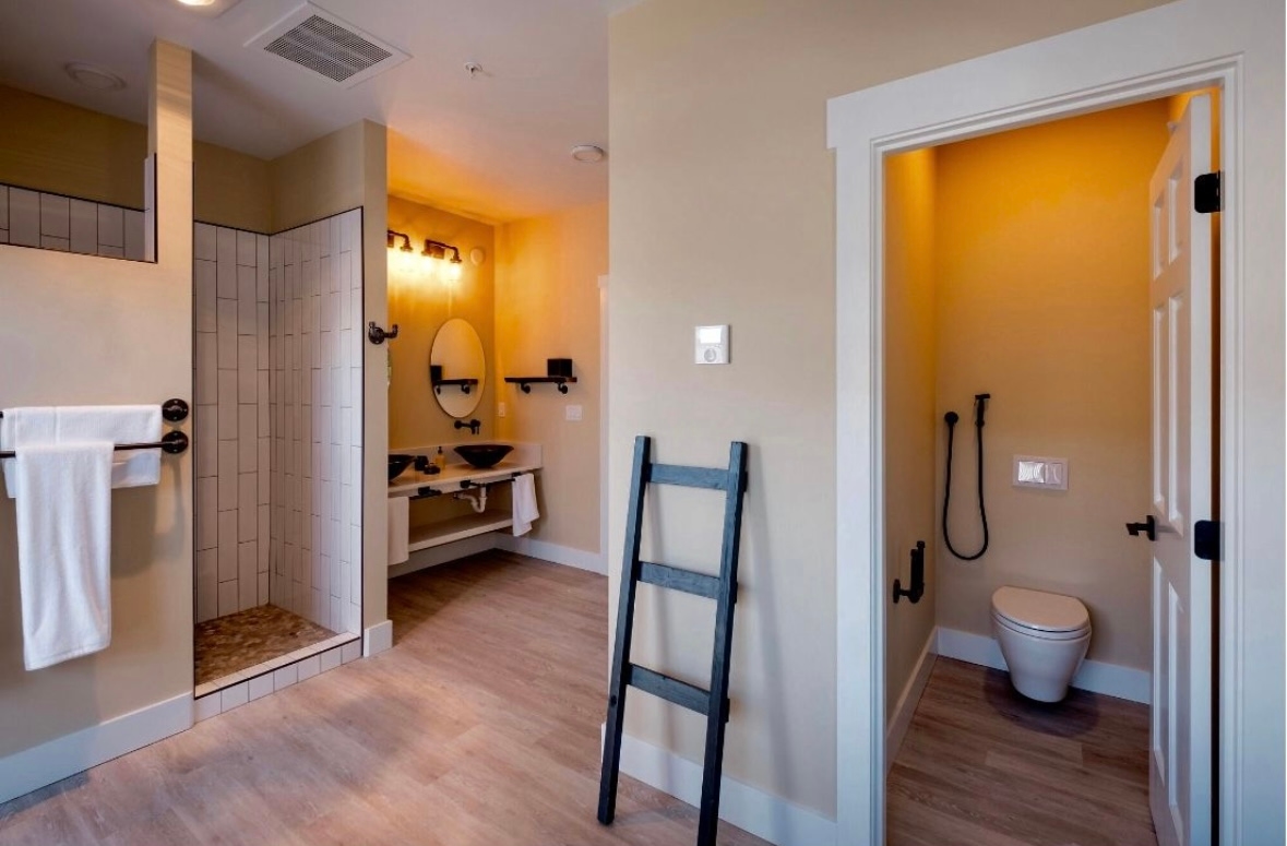 Bathroom with shower, double glass sinks and toilet