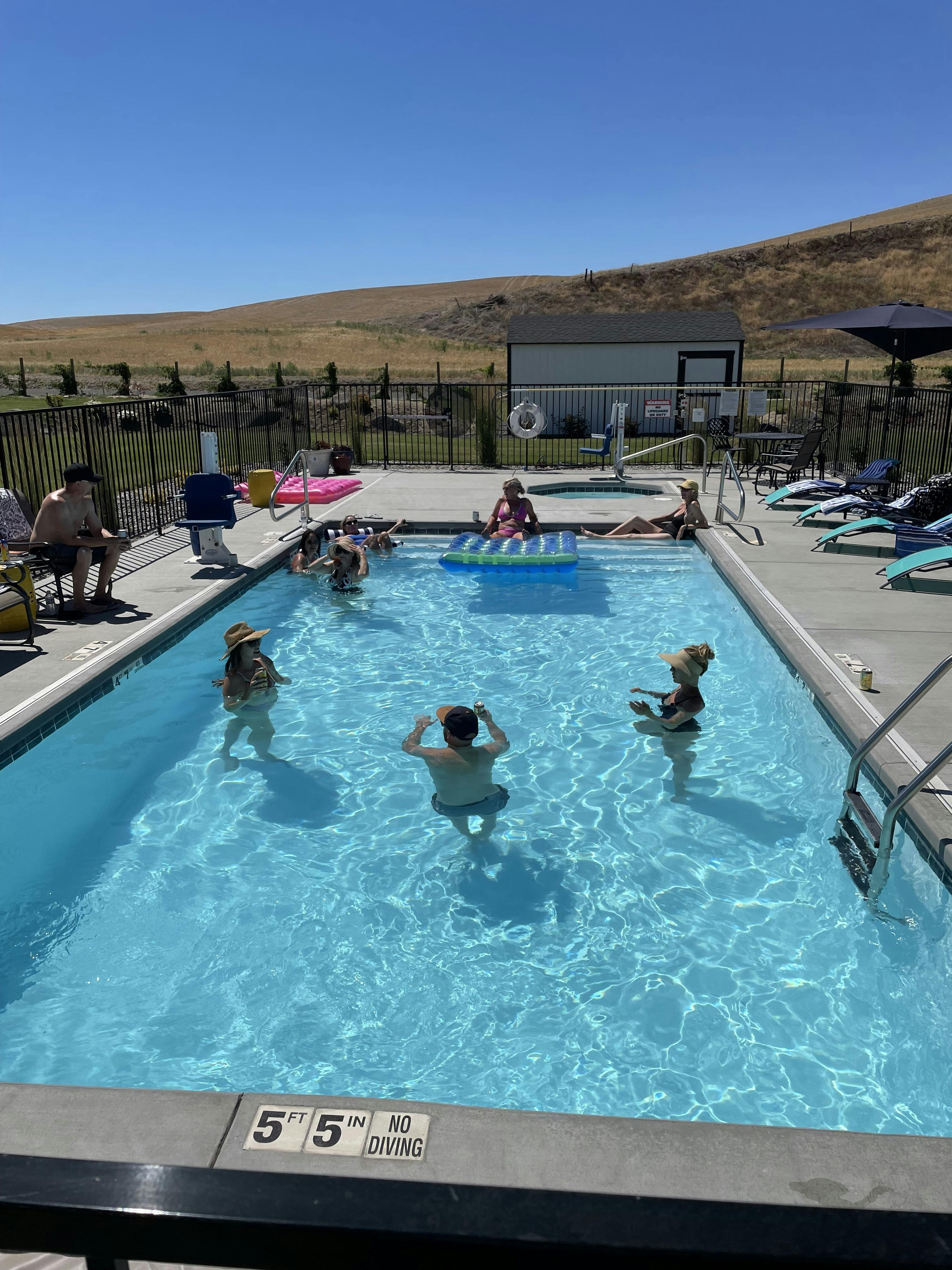 Heated outdoor pool and hot tub with views of the hills just steps from your suite