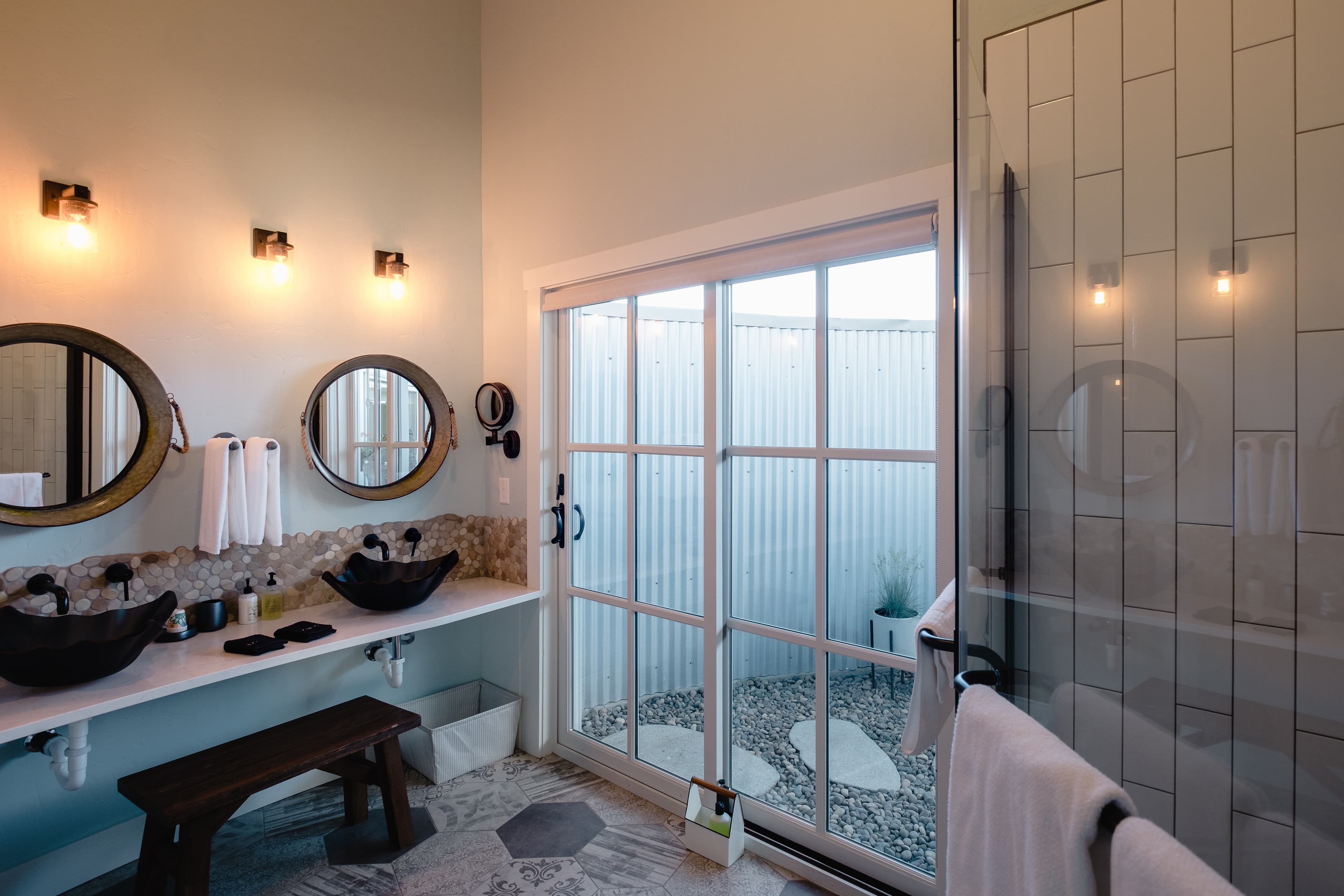 Bathroom with shower, double glass sinks and toilet